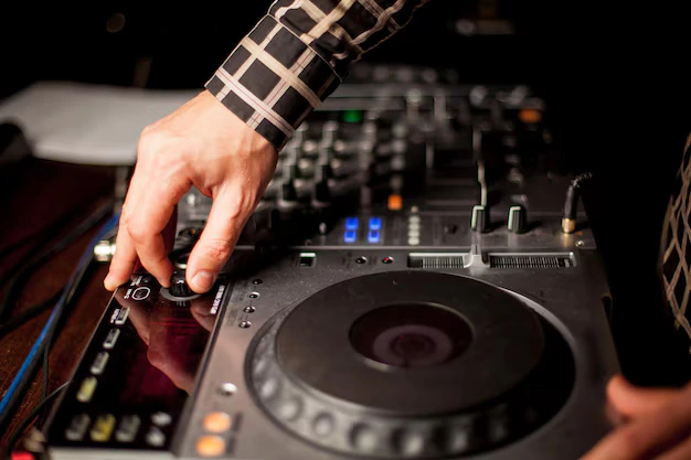 DJ mixing on turntables and mixer
