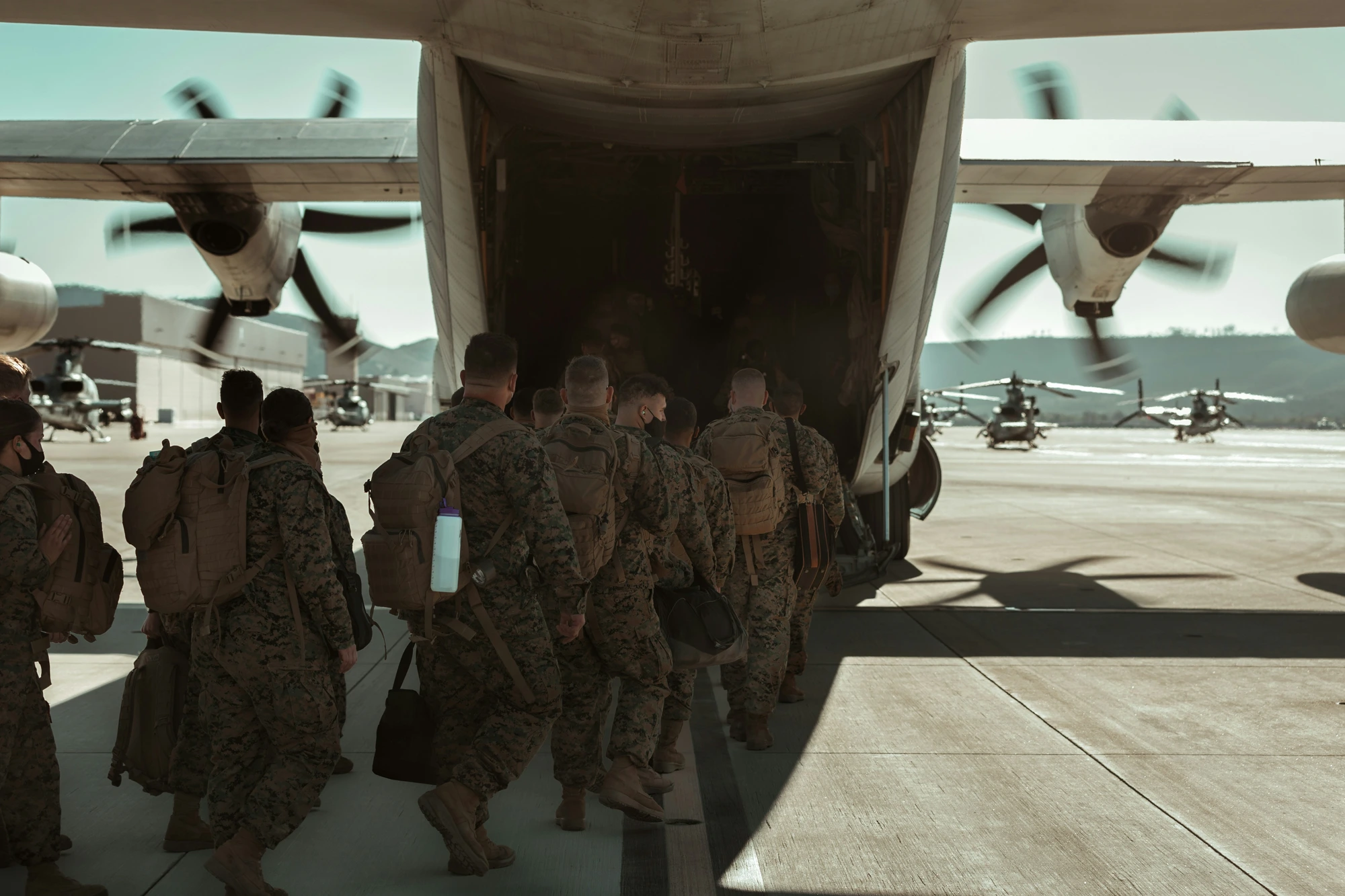 Service members boarding a military aircraft