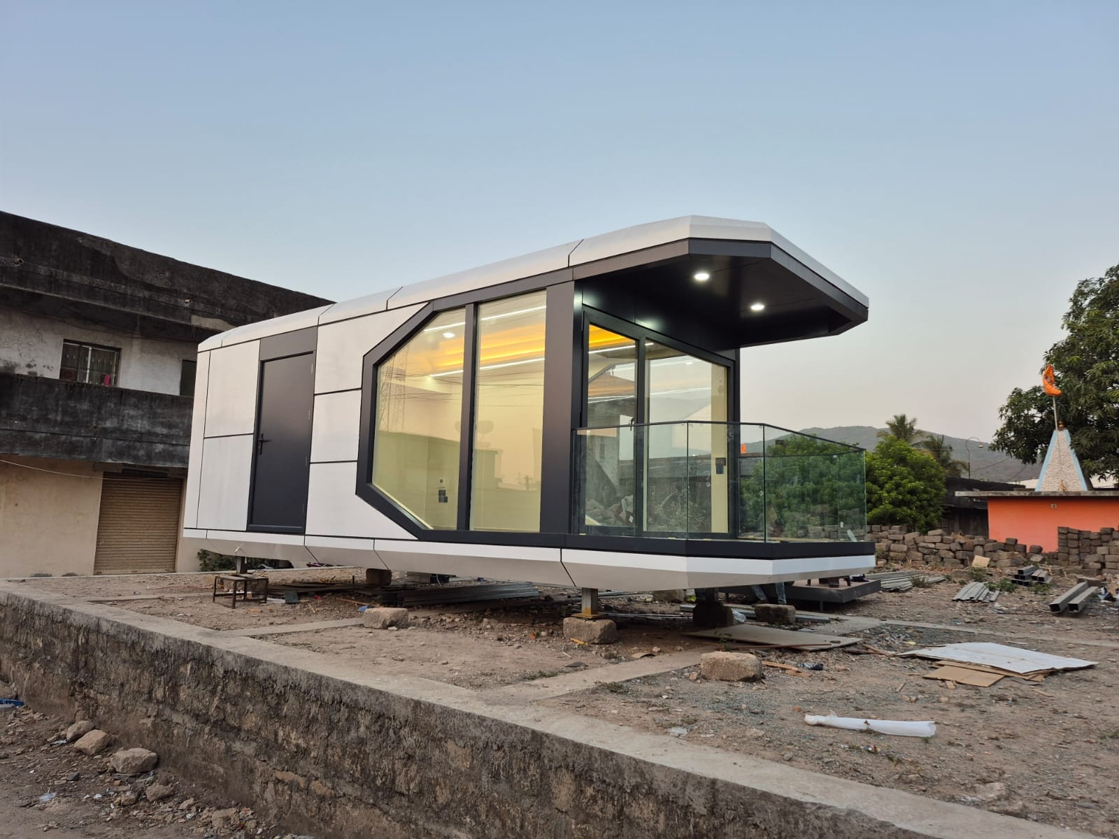 Modularoom CS25 Capsule Suite exterior — a compact modular guest accommodation with angled glazing and private balcony
