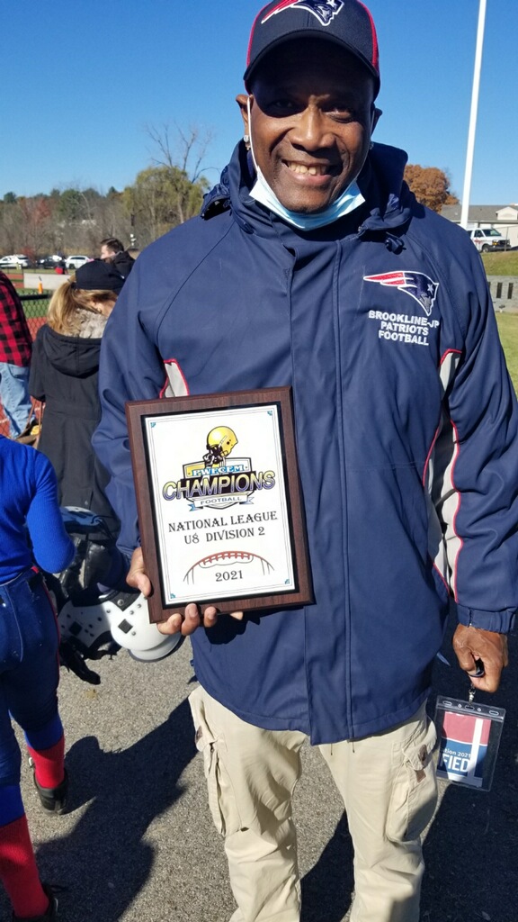 Coach with 2021 National League U8 Division 2 Champions plaque