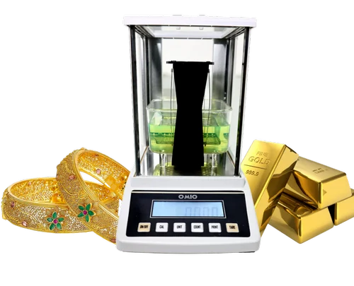 Omio Gold Testing Machine with gold jewellery and gold bars