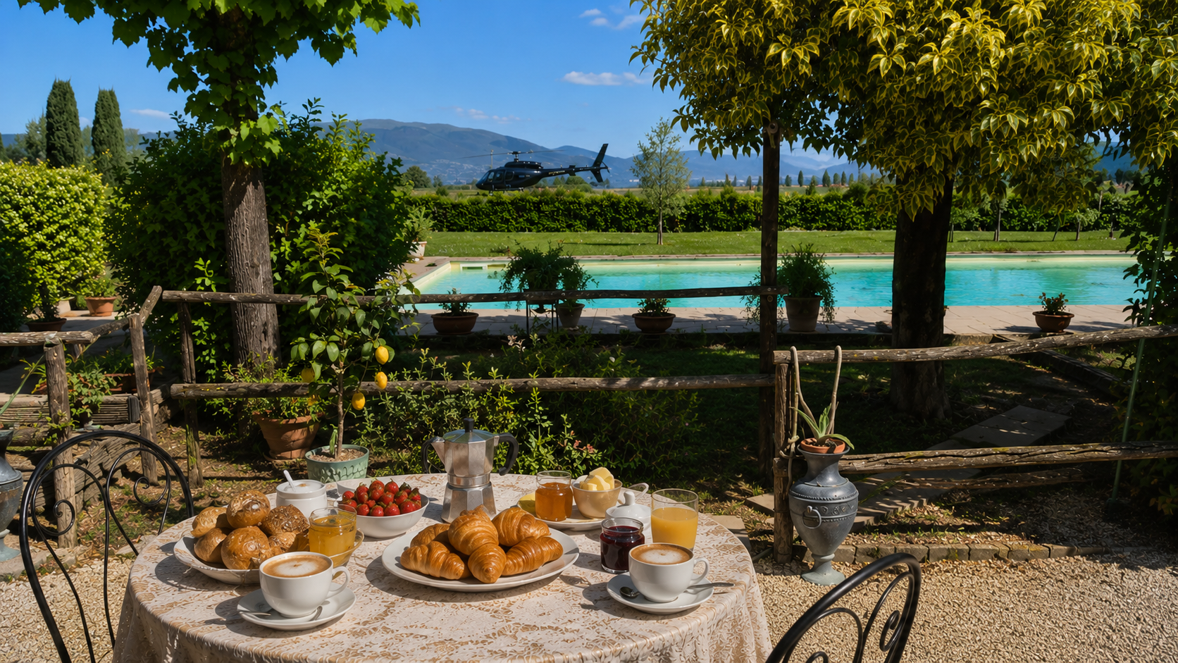 Colazione di benvenuto in giardino, con piscina ed elicottero sullo sfondo