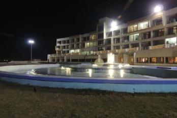 The property lit up at night with fountain - Sagar Darshan Guest House, Somnath