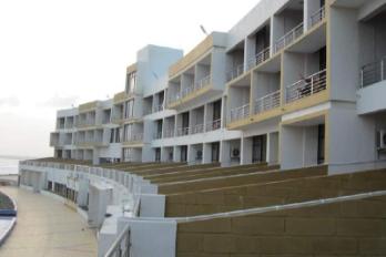 Sea-facing balconies along the curved facade - Sagar Darshan Guest House, Somnath